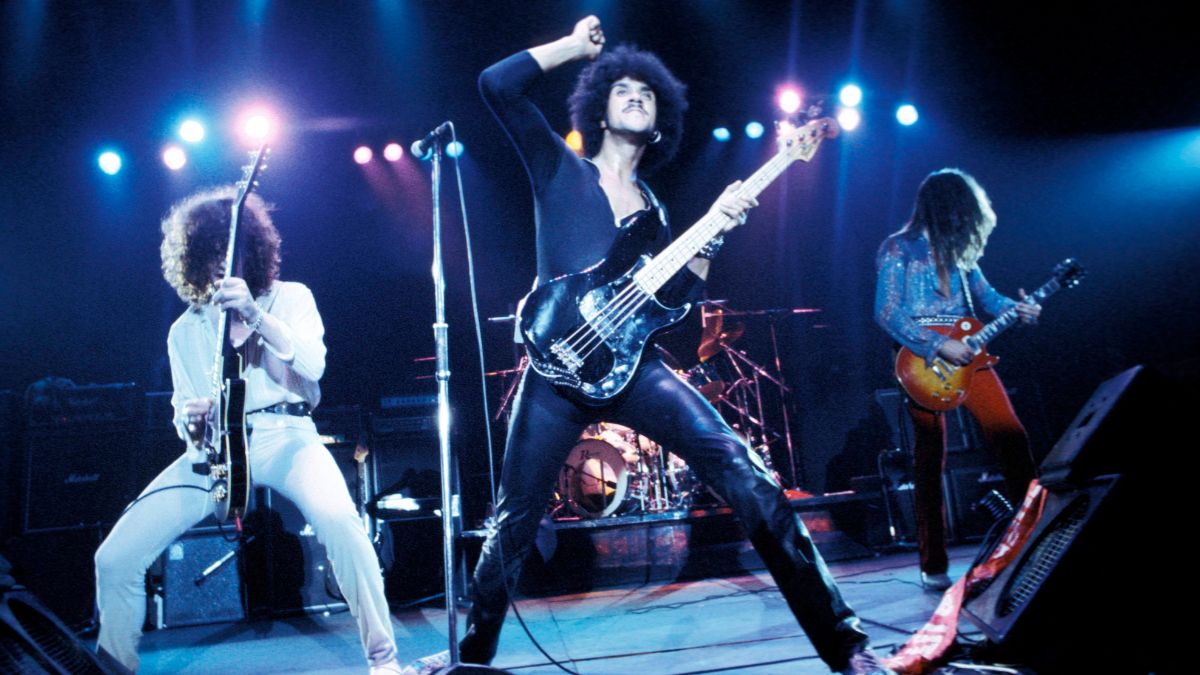 Photo of Brian ROBERTSON and Scott GORHAM and Phil LYNOTT and THIN LIZZY, L-R: Brian Robertson, Phil Lynott (wearing leather trousers), Scott Gorham performing live onstage