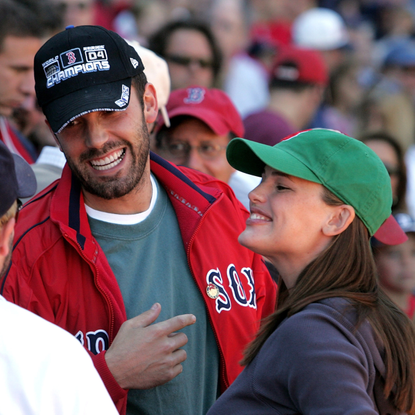 Actor Ben Affleck and wife, actress Jennifer Garner laugh with player Kevin Millar #15 of the Boston Red Sox prior to the start of the game against the New York Yankees at Fenway Park on October 1, 2005 in Boston, Massachusetts