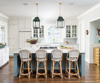 modern kitchen with white cabinets and walls and gray-blue island