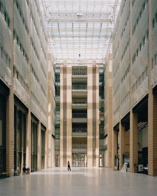 walking through Potsdamer Platz in Berlin and its postmodernist architecture, showing large scale buildings with transparencies and grids