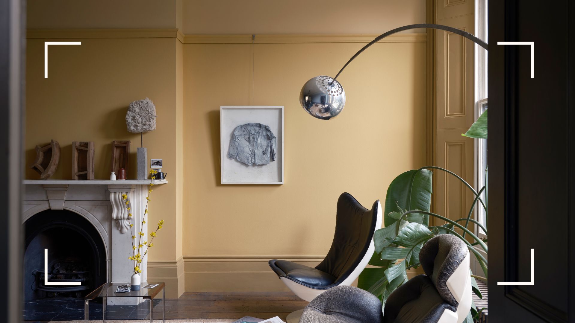 Yellow living room with contemporary furniture showcasing Farrow &amp; Ball's gradient layering paint trend