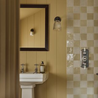 bathroom with cream painted wood panel walls and shower with cream coloured check tiles