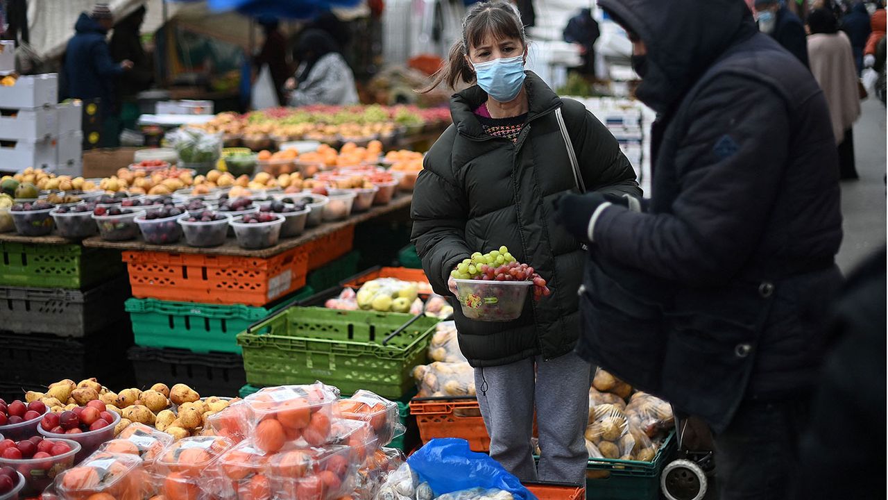 Person buying fruit at a market