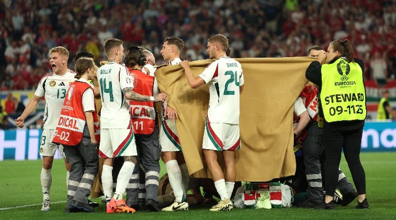 Hungary players hold up a blanket to shield team-mate Barnabas Varga as he receives medical treatment following a suspected collision against Scotland at Euro 2024.