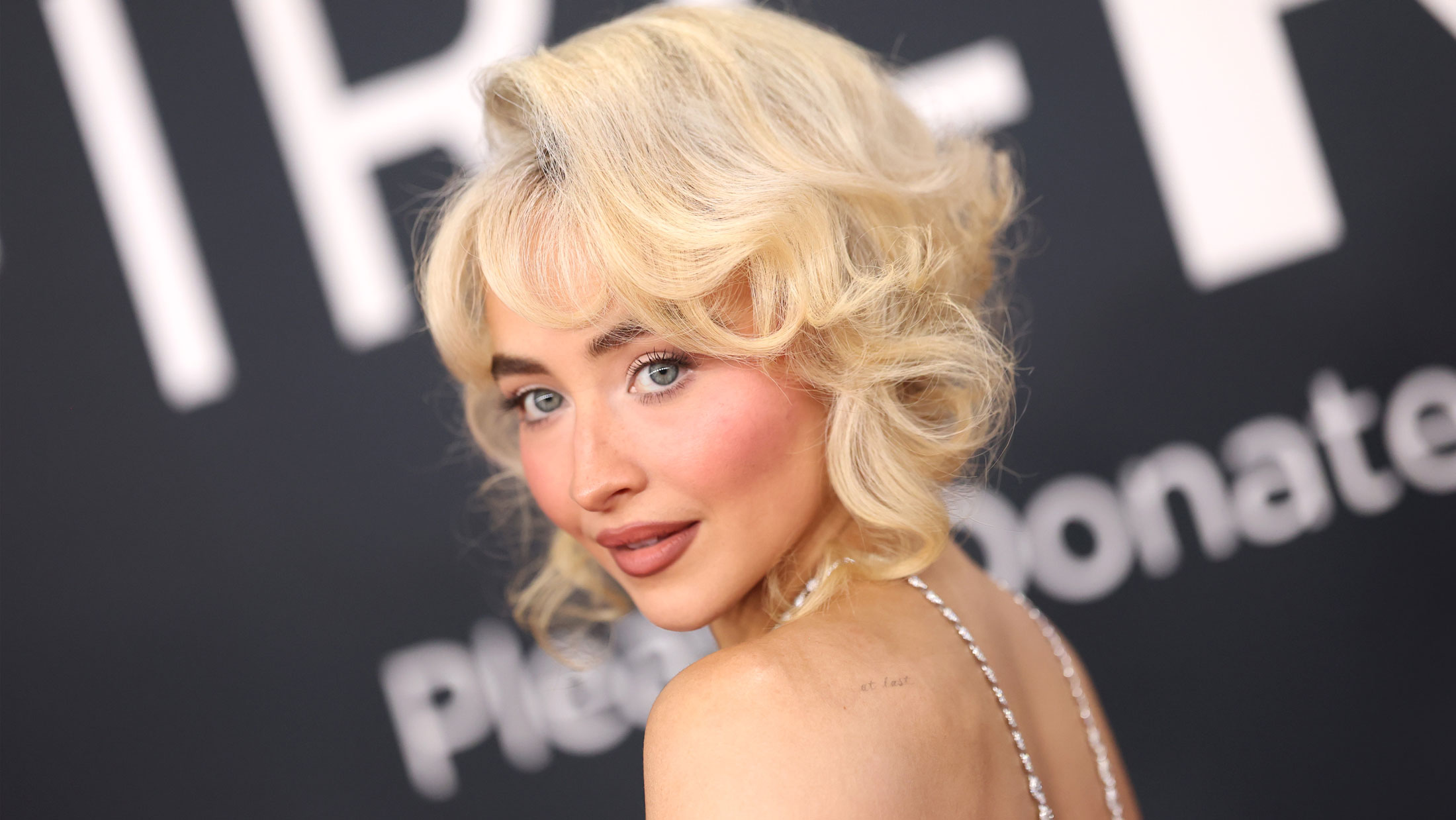 Sabrina Carpenter looks over her shoulder.