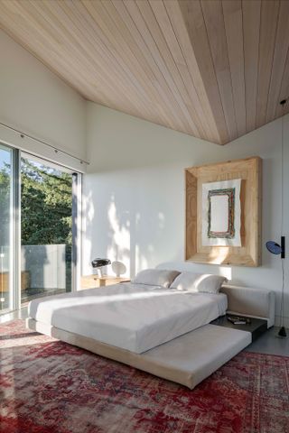 Bedroom in vancouver home with wooden angled ceiling