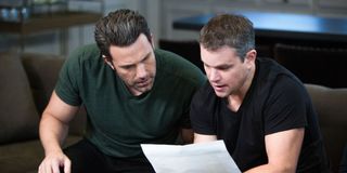 Ben Affleck and Matt Damon sit on a couch together and look at a piece of paper in Project Greenligh