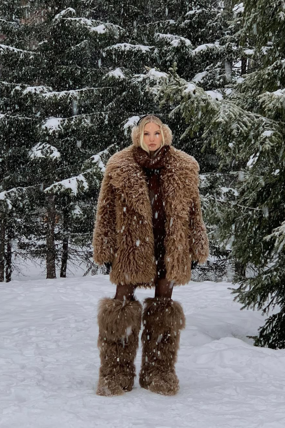 @leoniehanne wears faux fur boots shearling coat in snow