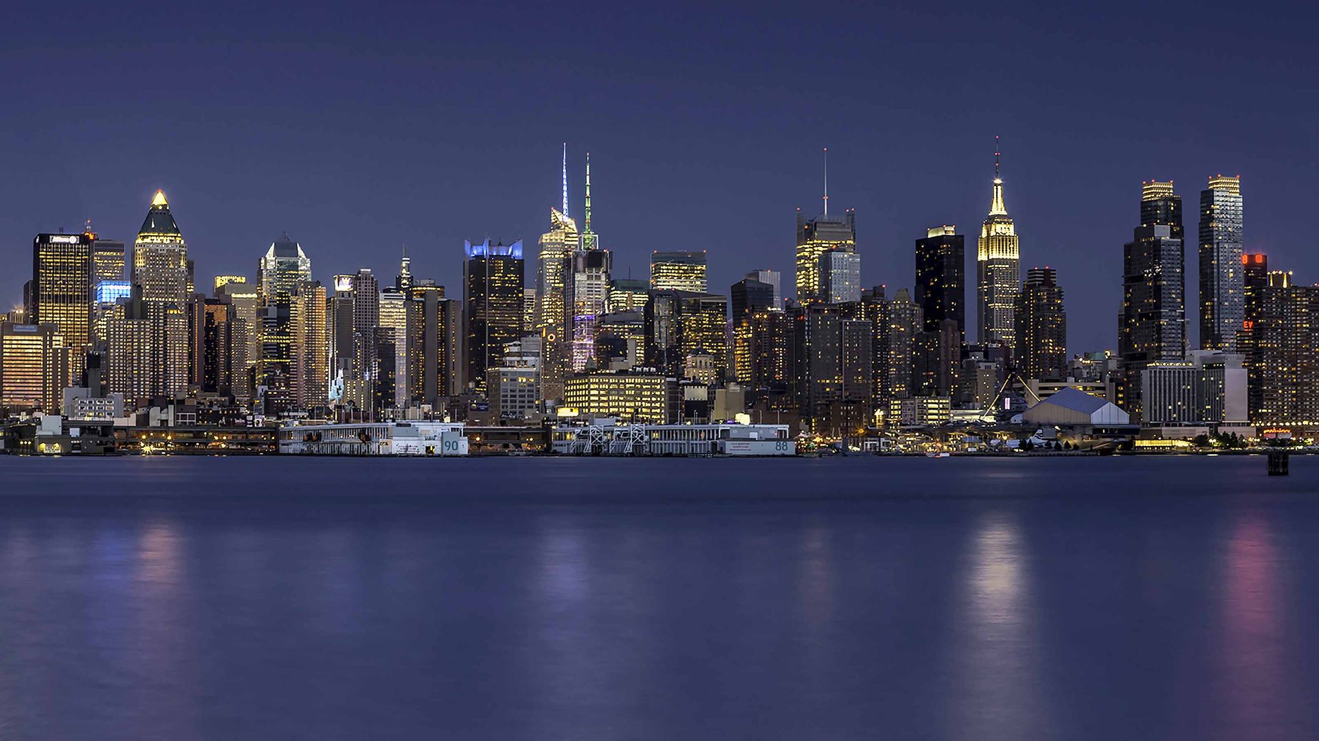 The Manhattan skyline at night as seen from across the East River