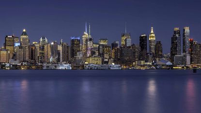 The Manhattan skyline at night as seen from across the East River