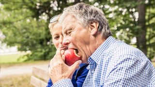 Man biting into an apple