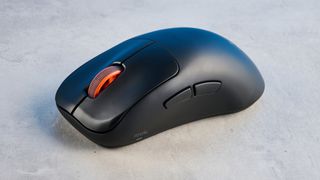 The SteelSeries Rival Pro mouse on a grey stone surface