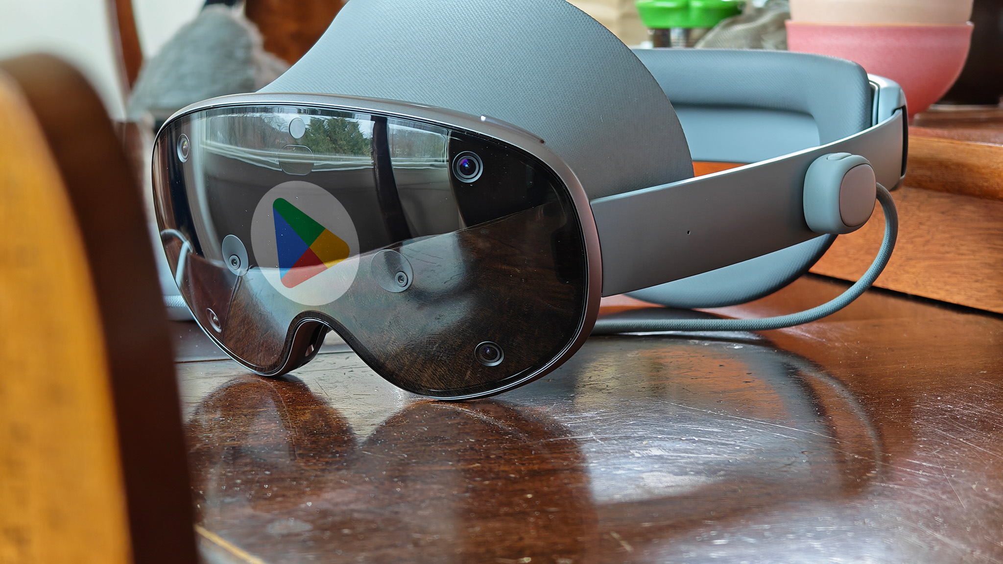 A Samsung Galaxy XR headset with the Google Play Store logo reflected in its front visor