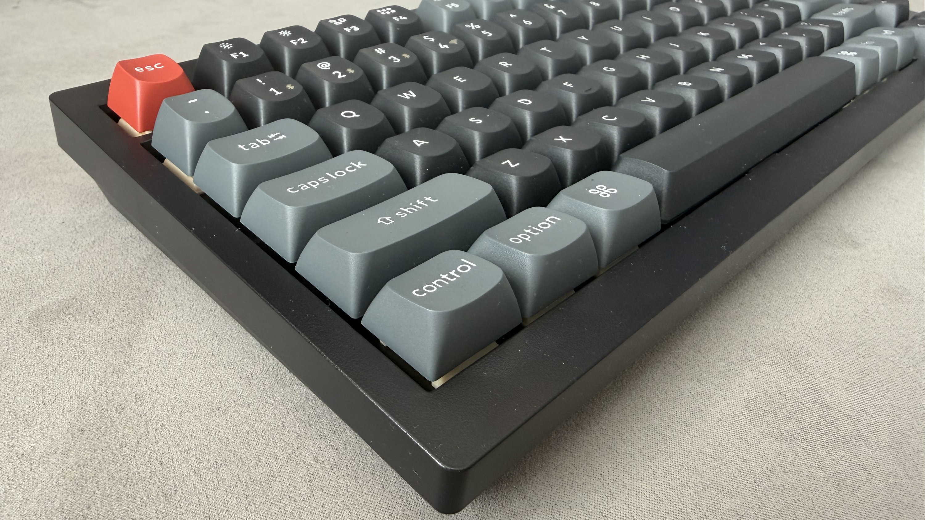 A closeup view of the bottom left corner of the Keychron V1 Ultra 8K, with the whole keyboard at a diagonal angle.