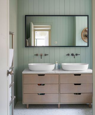 bathroom with double vanity and large mirror