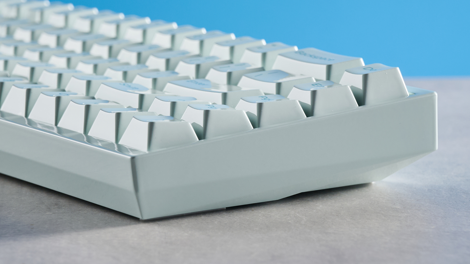 The Keychron Q16 HE 8K in light green on a stone surface