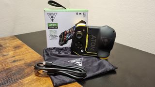 Turtle Beach Atom Controller unboxed with travel pouch and USB-C charging cable.