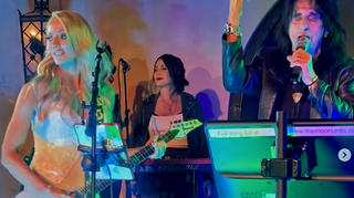 A screengrab of Nita Strauss playing guitar with Alice Cooper at her wedding in May 2024. They're depicted performing Cooper's hit "I'm Eighteen."