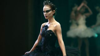 Natalie Portman is in a black tutu and black eye makeup on stage in the movie black swan