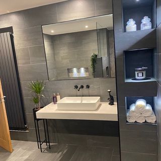 bathroom with white washbasin and black plant pot