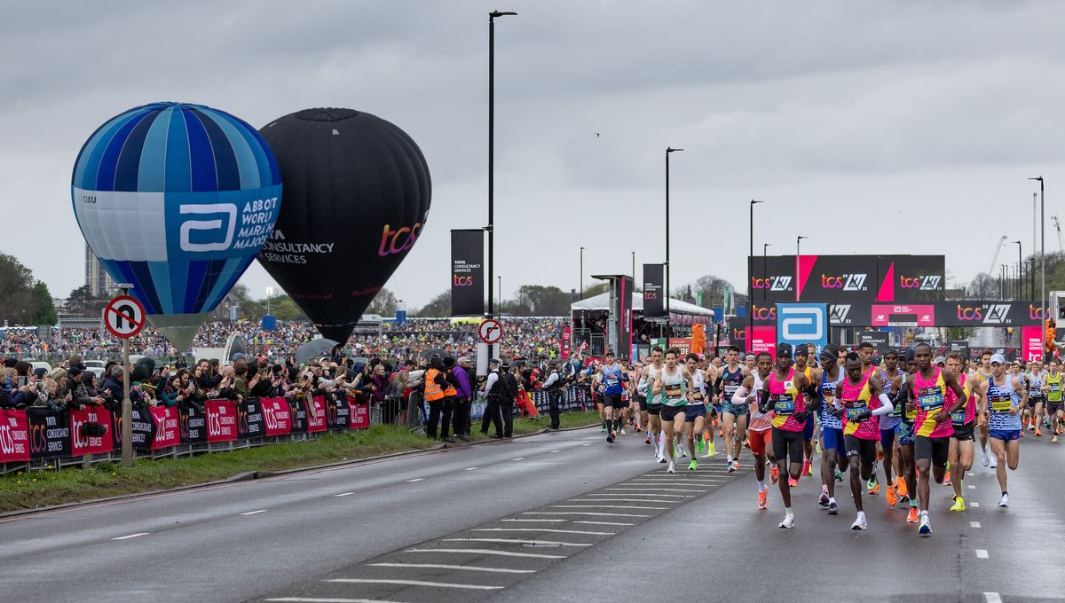 Spectators watch competitors in the Elite Men’s race and the mass start at the beginning of the TCS London Marathon on Sunday 23rd April 2023