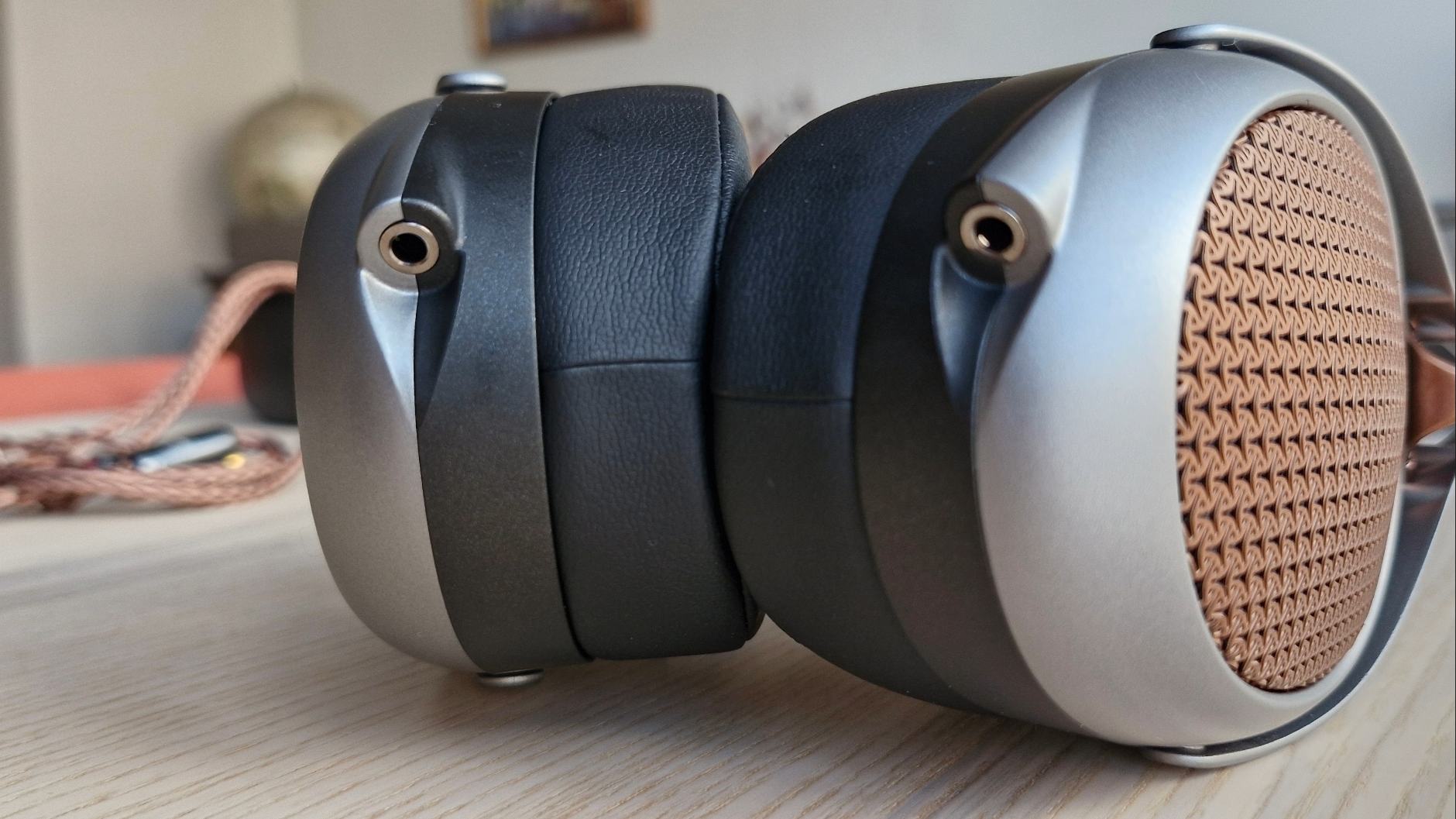 Meze Audio Poet open-back over-headphones on a wooden surface