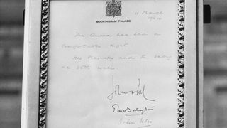 The birth notice of Queen Elizabeth II's new son, Prince Edward, outside Buckingham Palace, London, 11th March 1964. The notice reads: 'The Queen has had a comfortable night. Her Majesty and the baby are both well'.