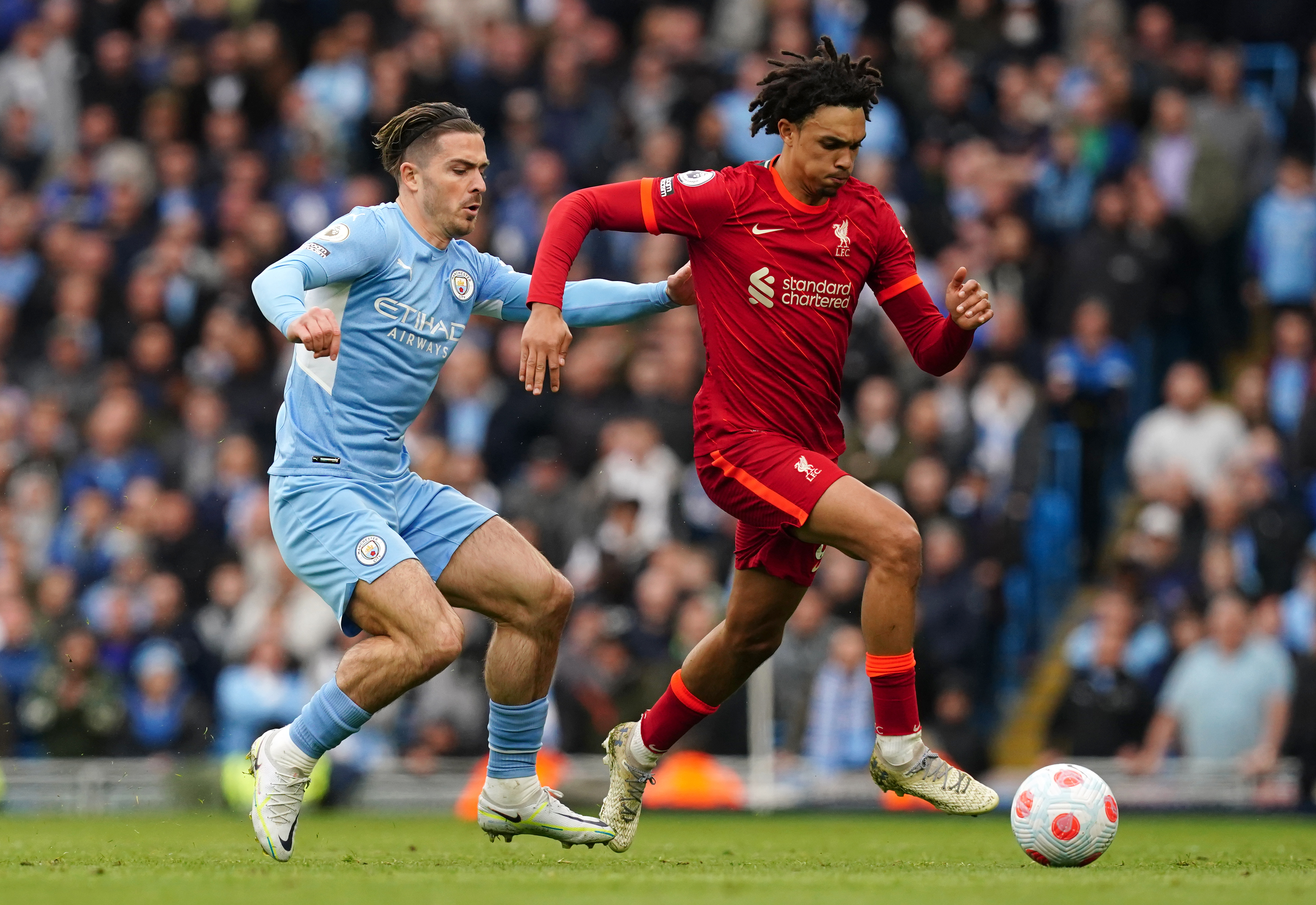 Manchester City’s Jack Grealish (left) and Liverpool’s Trent Alexander-Arnold battle for the ball during the Premier League match at the Etihad Stadium, Manchester. Picture date: Sunday April 10, 2022
