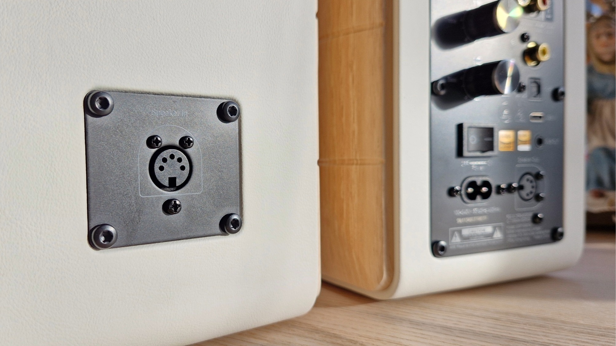 Rear panels of the Edifier S880DB MKII active bookshelf speakers on a wooden surface.