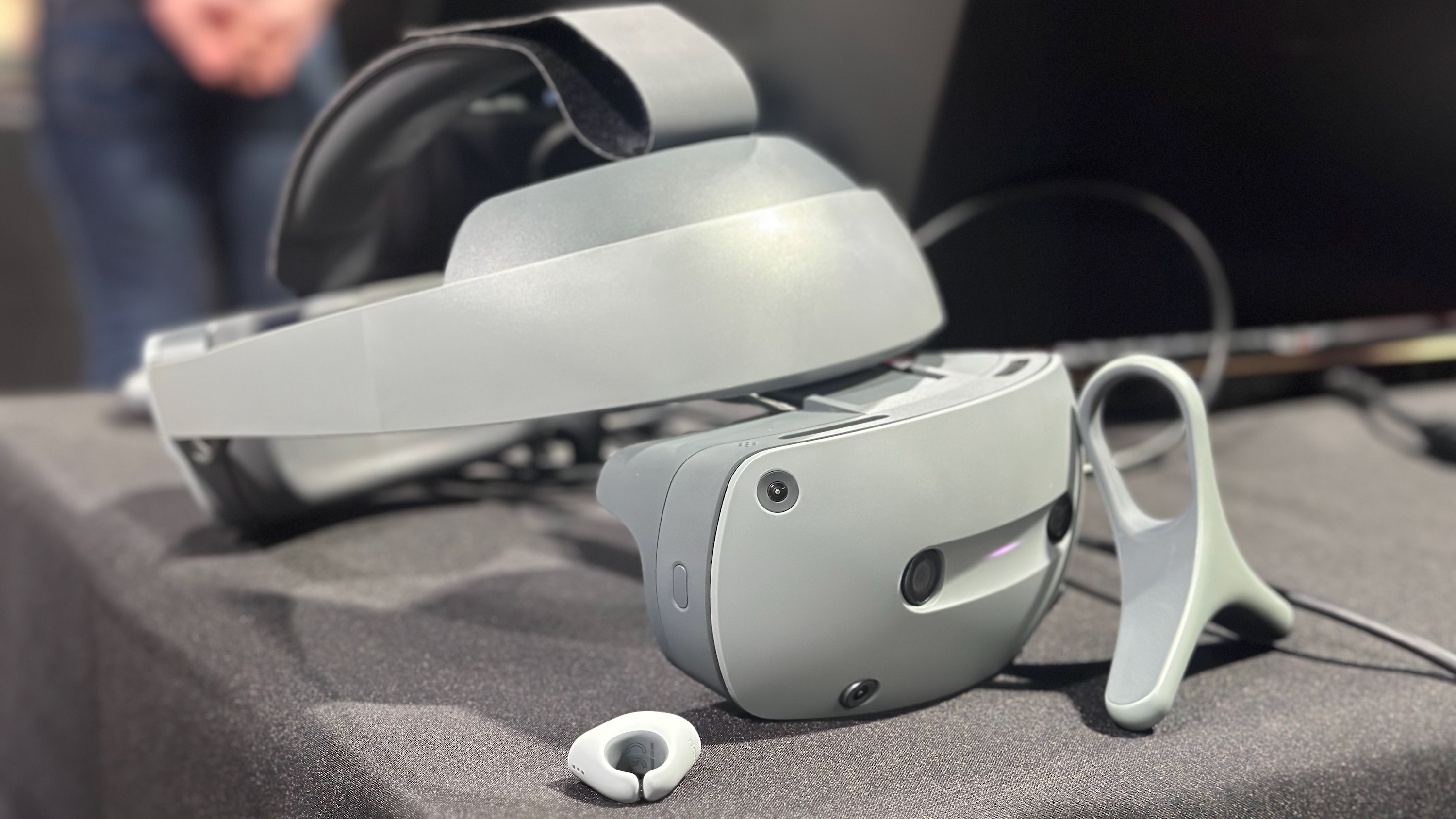 The Sony XYN headset with finger and ring controllers sitting on a grey table.