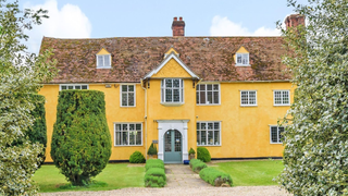 Yellow grade II house with 14th century origins set within mature gardens in Essex.