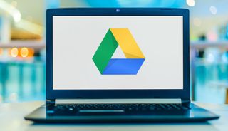The Google Drive tricolor triangle logo displayed on a laptop screen.