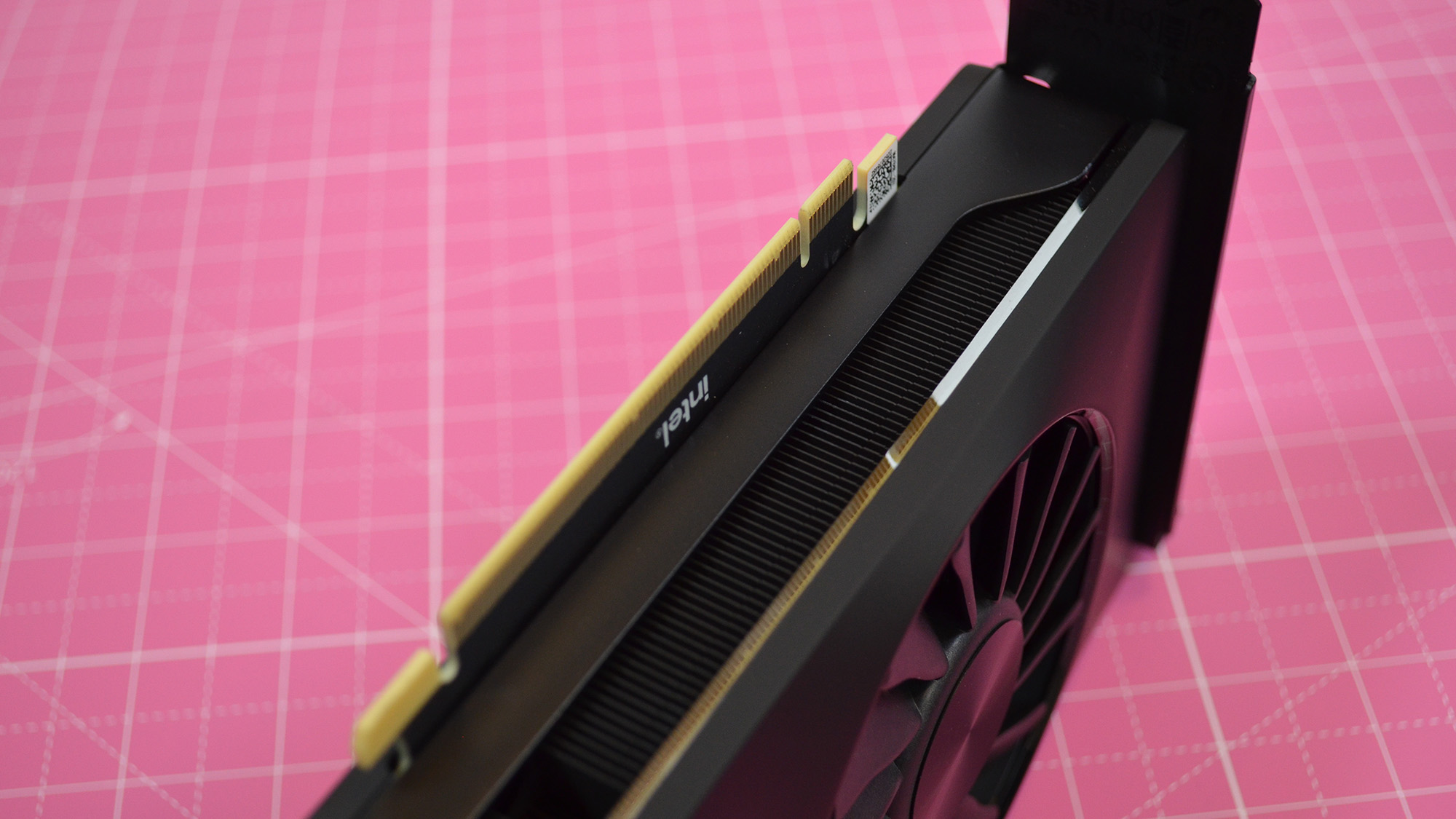 An Intel Arc A770 LE graphics card on a table with a pink desk mat