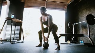 Woman doing a deadlift at home