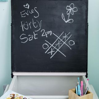 room with blackboard sky blue wall and wooden pen stand
