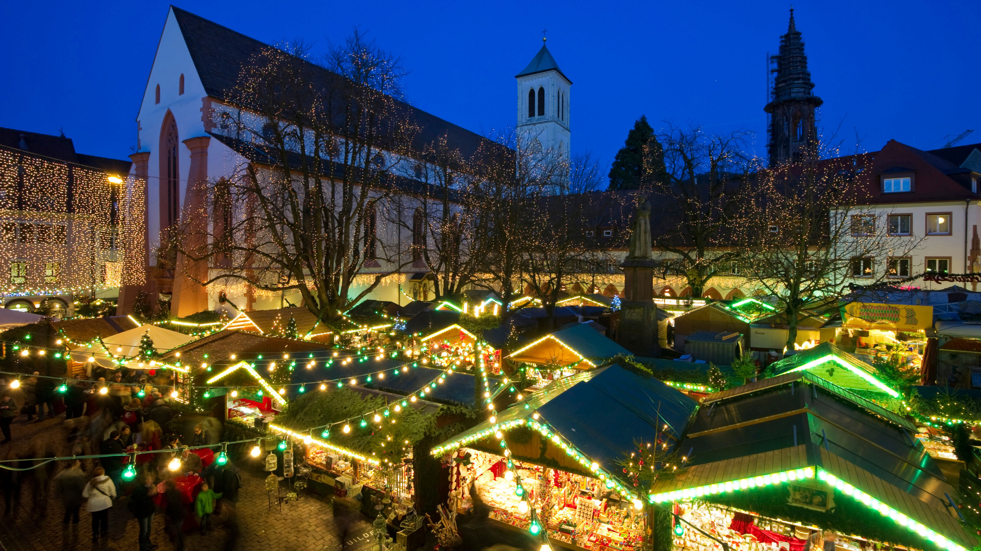 An aerial night-time view of the Christmas market in Freiburg, Germany