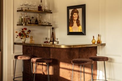 A home bar with metallic accents and brown bar stools