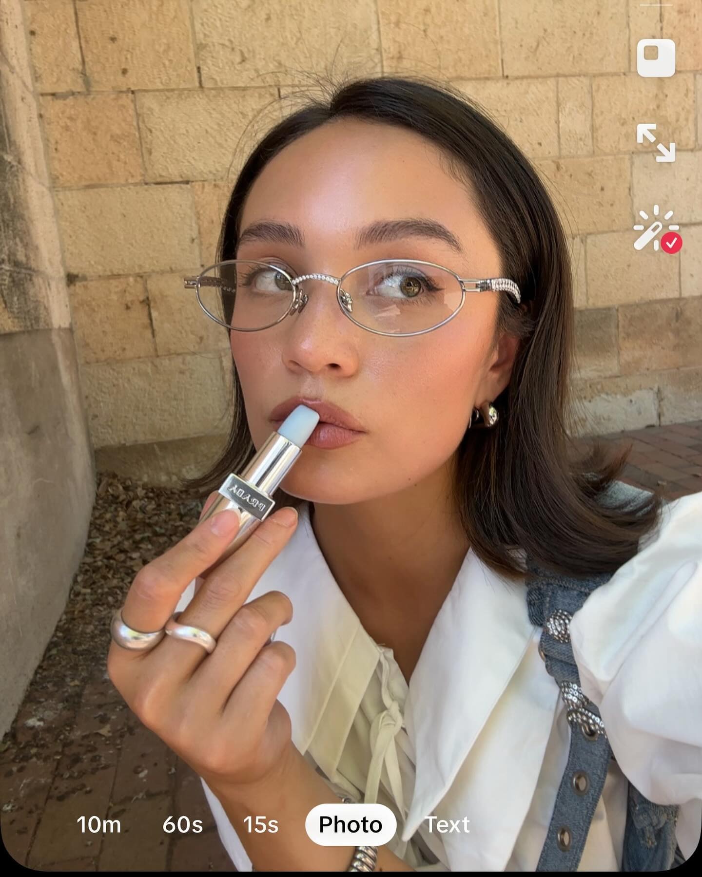 Summer Rachel Warren applying Prada lip balm.