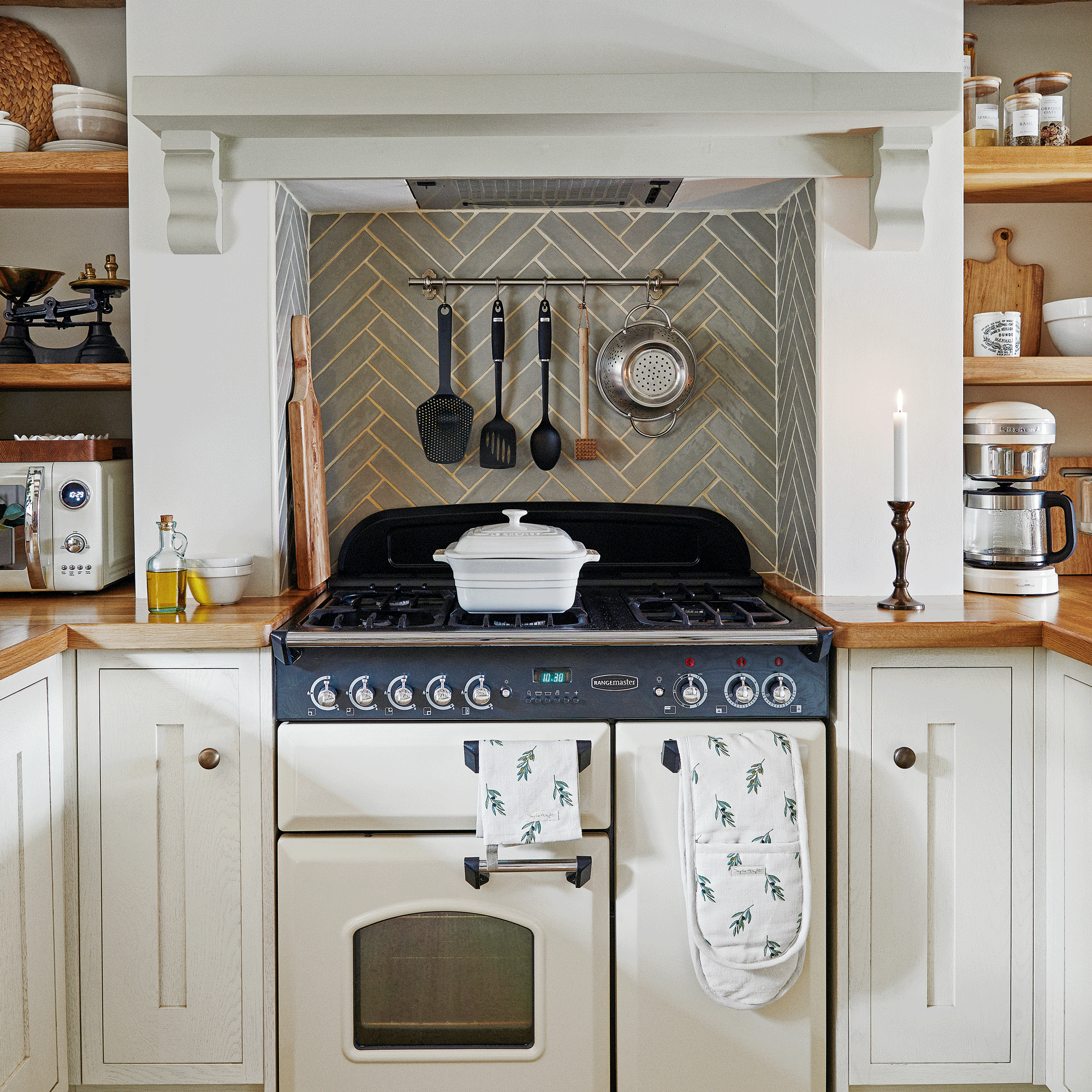 a small range cooker in a neutral kitchen with Shaker cabinets and a wooden worktop