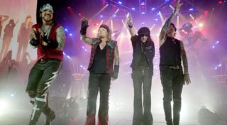 (from left) Mötley Crüe's Nikki Sixx, Vince Neil, Mick Mars and Tommy Lee take a bow at Nationals Park in Washington, DC on June 22, 2022