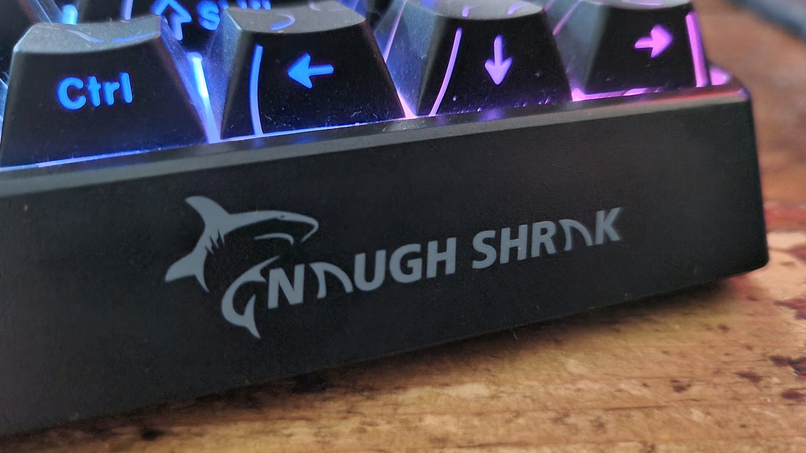 A close up of the "Naugh Shark" text on the front of the Gamakay x NaughShark NS68 gaming keyboard