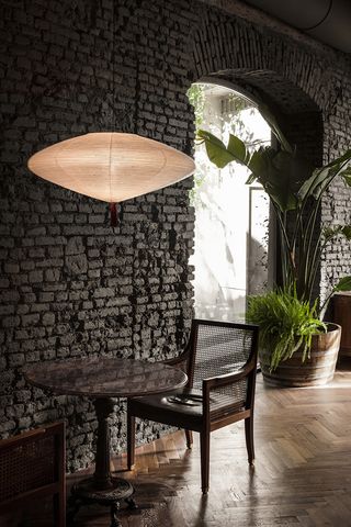 Table and chair under a low hanging lamp shade