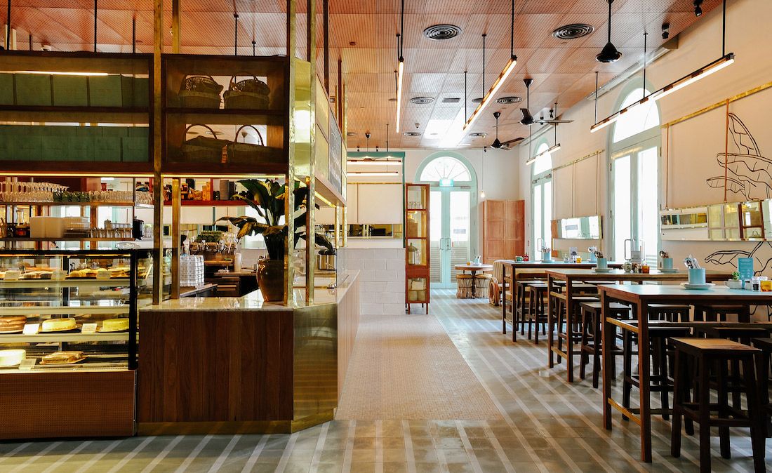 Wooden tables &amp; chairs next to food counter