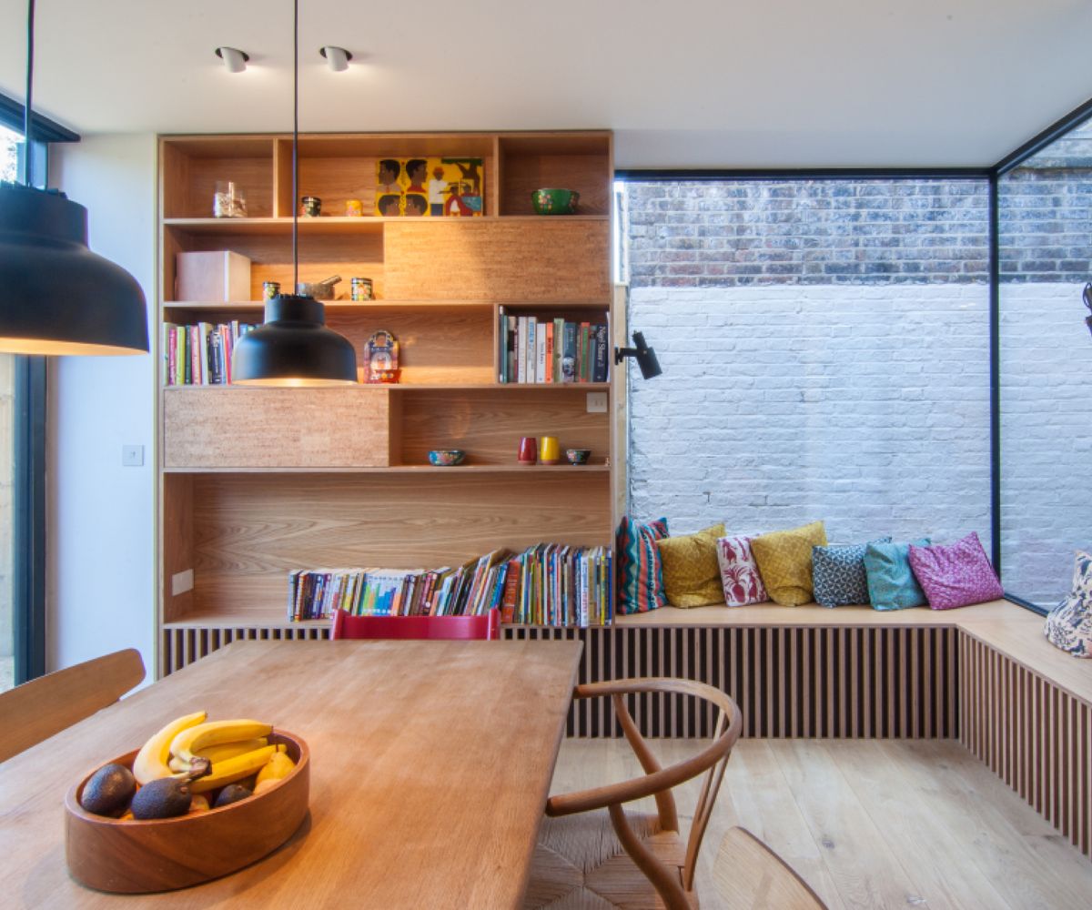 small house extension with glazed corners, built in storage and window seats