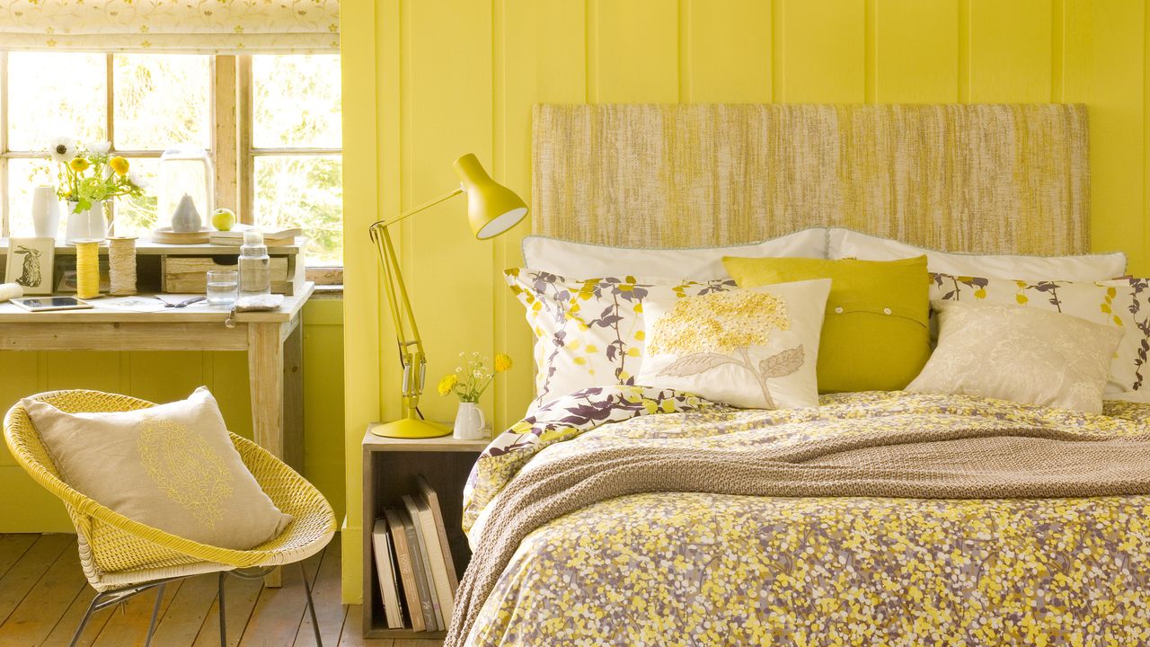 Yellow bedroom with wall panelling and large table light