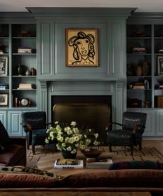 living room with blue-green walls with shelving, traditional decor 