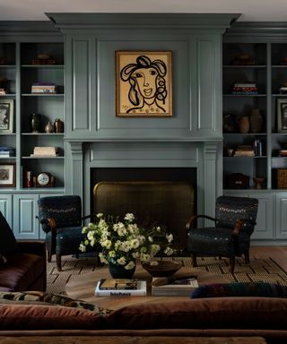 living room with blue-green walls with shelving, traditional decor