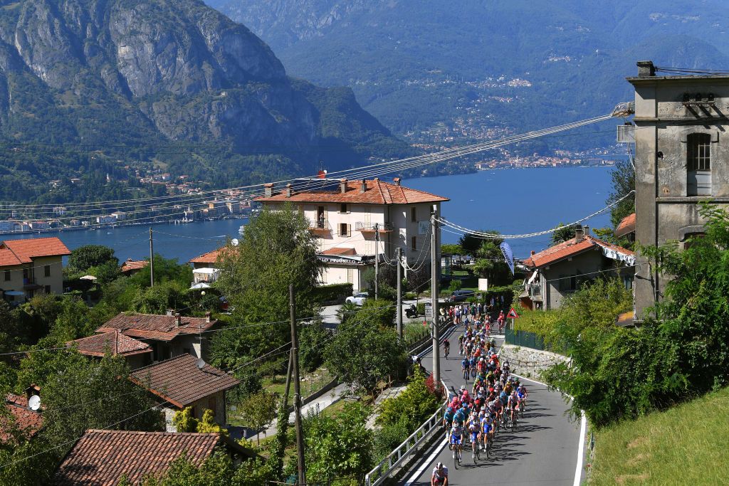 The peloton begins the picturesque ascent of Madonna del Ghisallo from Bellagio Village on the shores of Lake Como