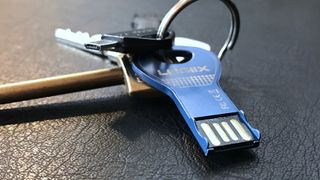 A USB-A flash drive on a keyring.