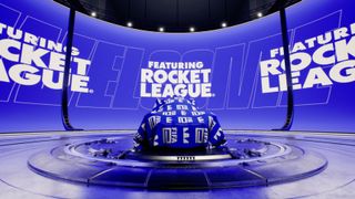 An image of a Rocket League car underneath a FIFA-branded shround on a virtual stage. The text "Featuring Rocket League" is prominently displayed on a screen behind it.
